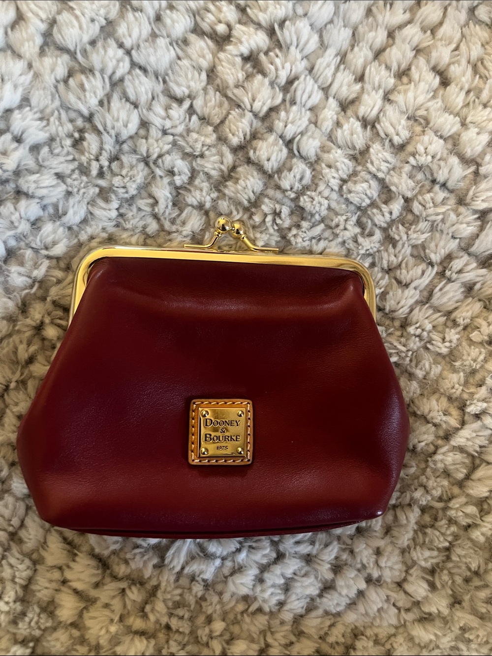 Dooney & Bourke burgundy leather kiss-lock coin purse with gold hardware